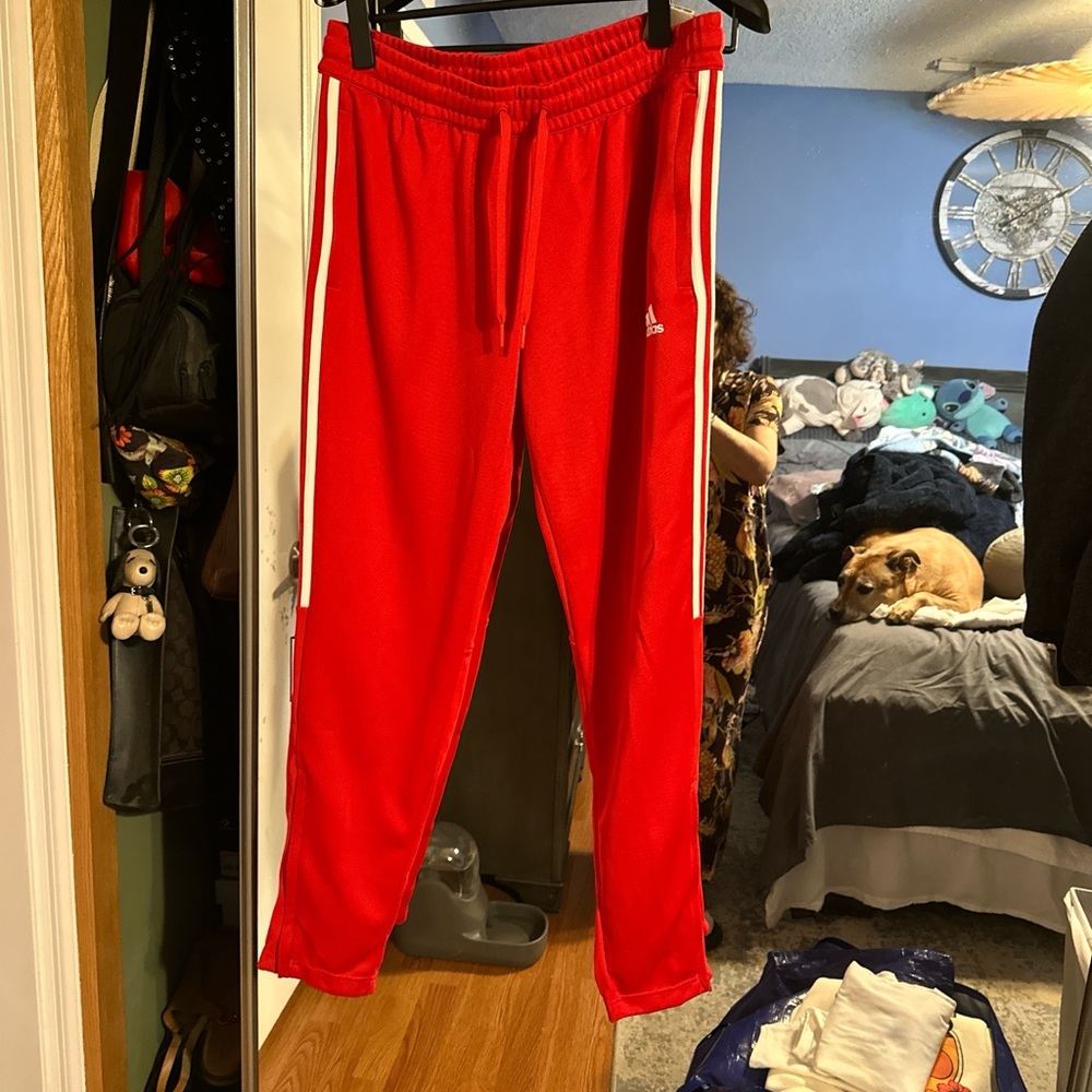 Adidas womens Red Joggers with White Stripes and zippers at the ankles